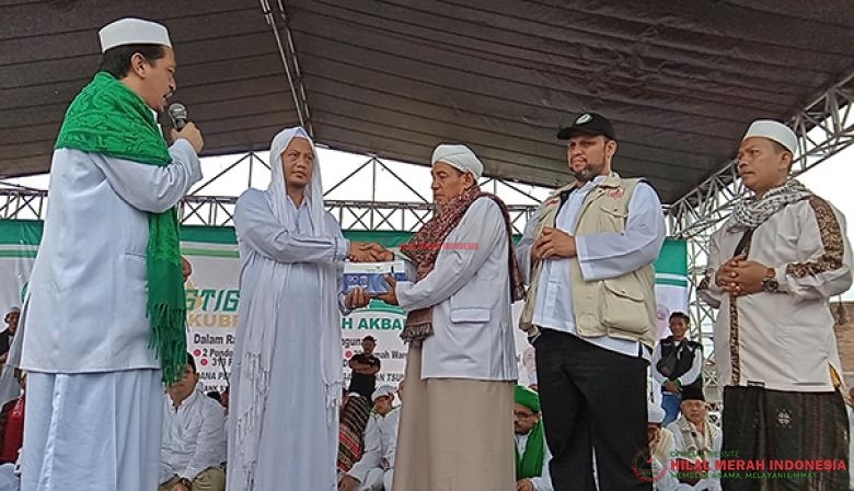 Ketua DPD FPI Banten, KH. Fakhrurozi menyerahkan secara simbolis bantuan donasi untuk yatim-piatu dan dhuafa kepada Ketua DPW FPI Cibaliung, Mama H. Ujang