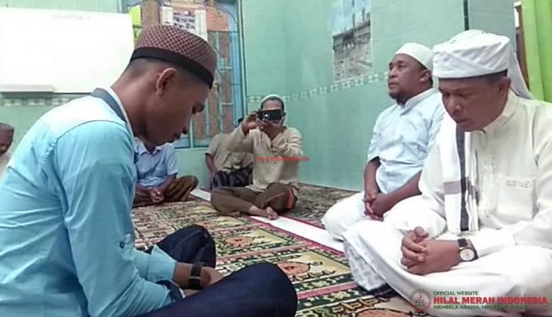Ustadz Riza Azhari, Ketua DPW FPI Langkat (kanan) saat membimbing Maruli (kiri) mengucapkan dua kalimat syahadat.